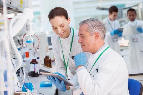 Scientists using tablet computer in laboratory Foto stock