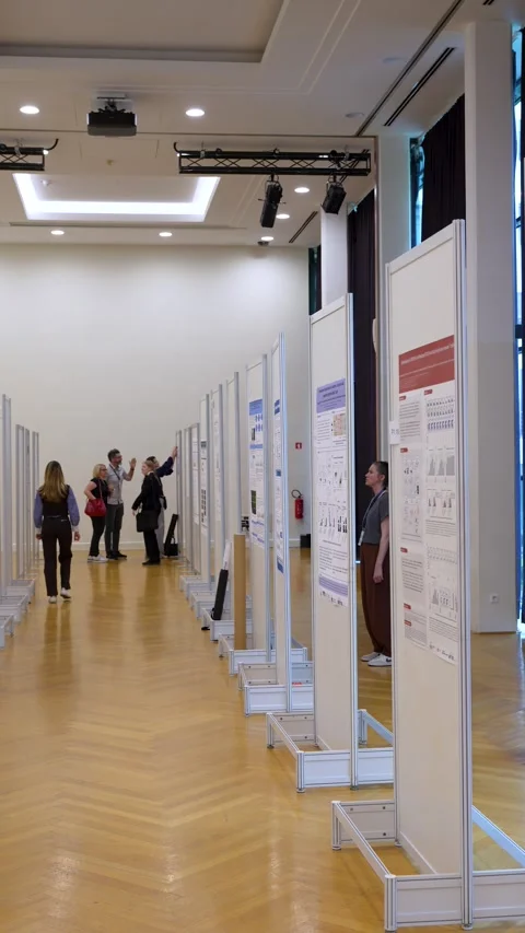 Scientists viewing research posters during academic conference session Stock Footage 334776436
