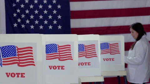 Scientists voting at booths in polling station HD Stock Footage 137755559