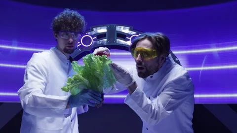 Scientists in white lab coats testing liquids on greenery Stock Footage 240331595