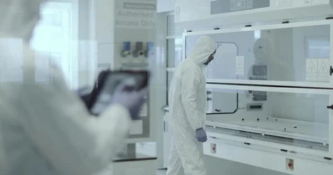Scientists working in a biohazard area lab Stock Footage 106932911