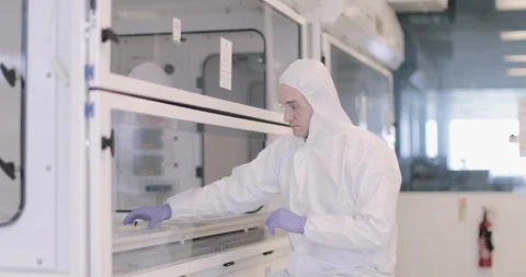 Scientists working in a biohazard area lab Stock Footage 106937486