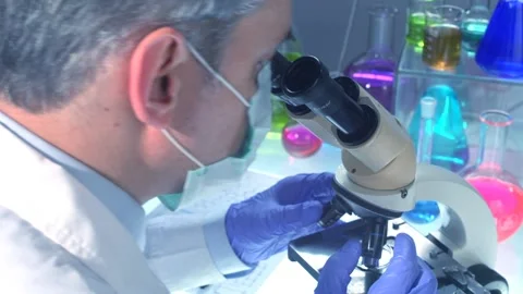 Scientists Working In Laboratory with microscope Stock Footage 200741799