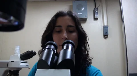 Scientists working in a laboratory. Using a microscope Stock Footage 36429457