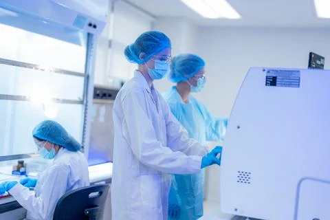 Scientists working in a modern laboratory during a research session with ad.. Stock Photos
