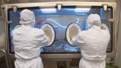 Scientists Working on Pharmaceutical Industry in a Clean Room Stock Footage 76137452
