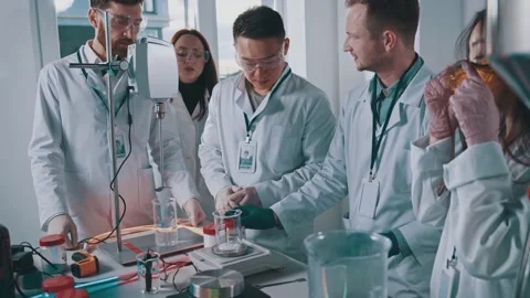 Scientists working in professional laboratory. Cooperative team of researchers Stock Footage 143986314