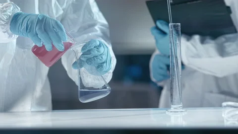 Scientists working with tubes and liquids in laboratory Stock Footage 149247323
