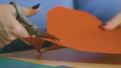Scissor cutting red paper teacher slow motion Stock Footage