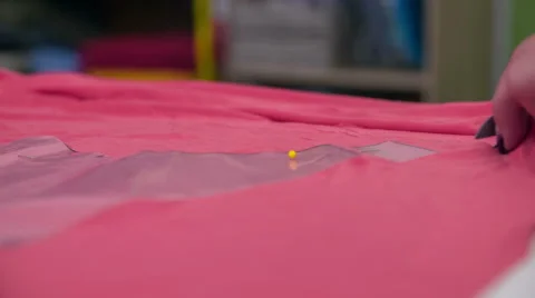Scissor cutting through pink textile close up Stock Footage 41013249