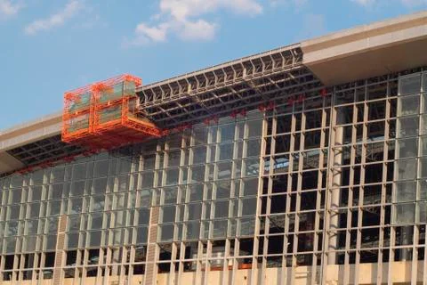 Scissor elevated lift platform. Multi-storey with many glass Windows .backgro Stock Photos