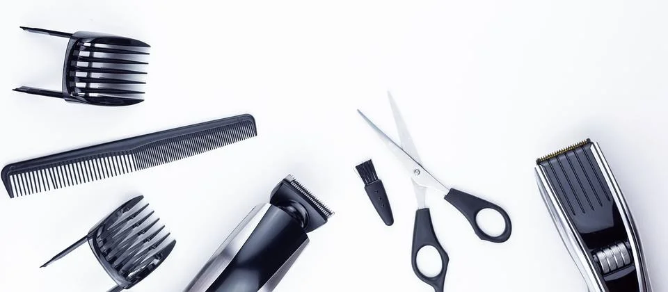 Scissors and combs on white Stock Photos