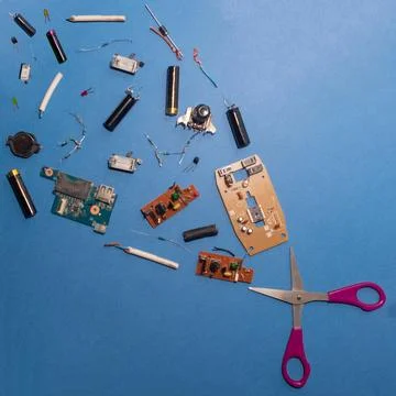 Scissors and electrical components flat lay. Creative design concept of technolo Photos
