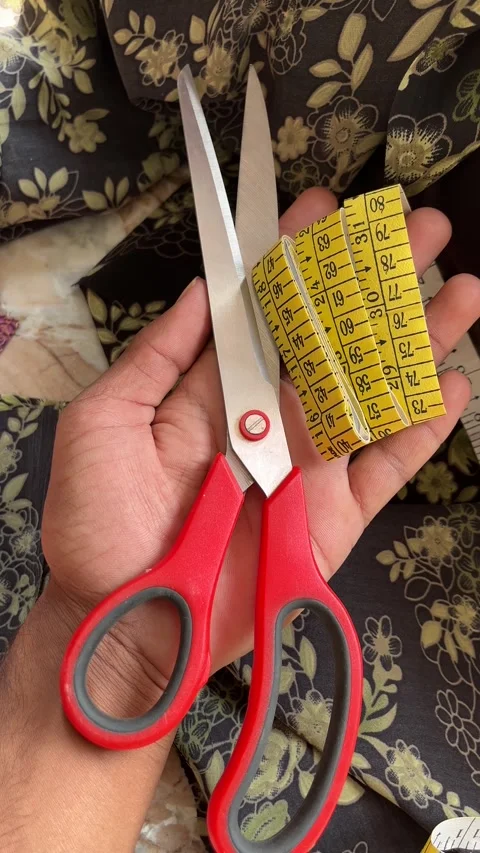 Scissors and Measuring Tape Held in Hand for Tailoring Concept 스톡 동영상 321674271