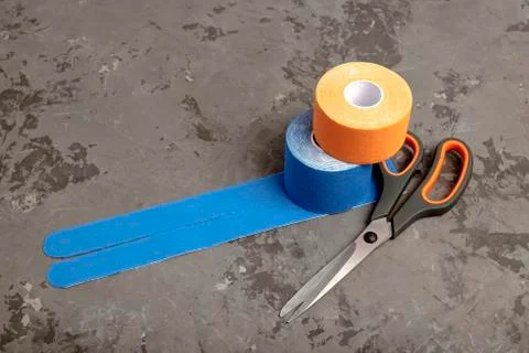 Scissors and two rolls special kinesiology tape for healing pain, aches and t Stock Photos