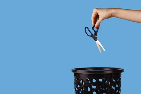 Scissors are thrown in the trash can. Stock Photos
