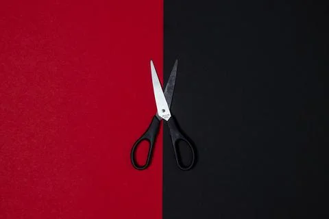 Scissors on a black-red background. Background for an inscription or logo Stock Photos