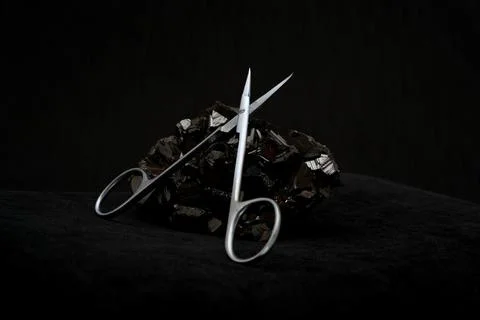 Scissors on black stone 스톡 사진