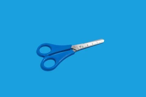 Scissors on a blue background Stock Photos