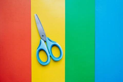 Scissors for childrens creativity on colored cardboard background Stock Photos