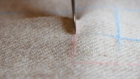 Scissors cut the beige twwed suit fabric cloth Skillful seamstress's fingers Stock Footage 128993482