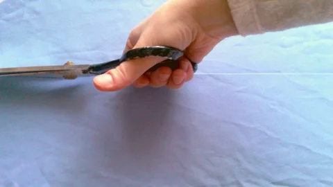 Scissors cut blue fabric Stock Footage 71524925