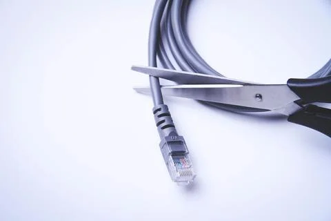 Scissors cut internet cable. Internet shutdown. Cut internet cable. Foto stock