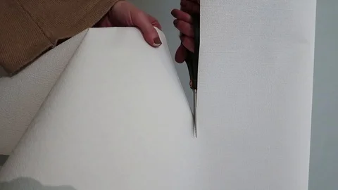 Scissors cut paper. View at female hands of the designer, cut with scissors Stock-Footage 128447341