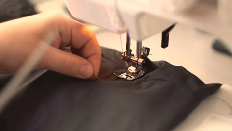 Scissors to cut thread on black fabric 4K Video stock 102470510