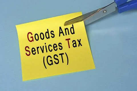 Scissors that cut yellow notepad with text on a blue background. Stock Photos