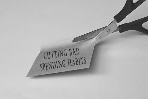 Scissors that cut yellow notepad with text on a black and white background. Stock Photos