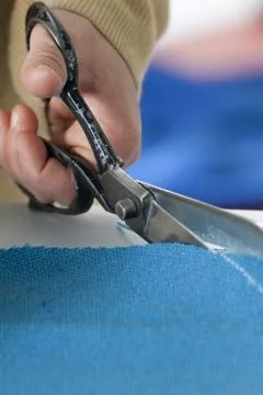 Scissors cutting cloth Stock Photos