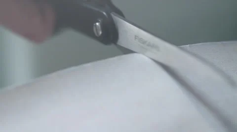 Scissors cutting into material Stock Footage 60747339