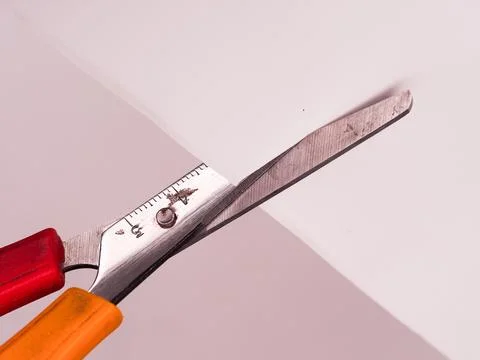 Scissors cutting paper Stock Photos