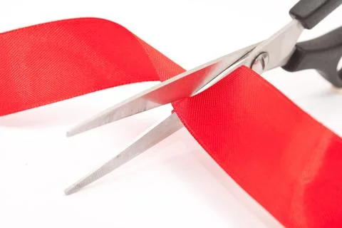 Scissors cutting red ribbon Stock Photos