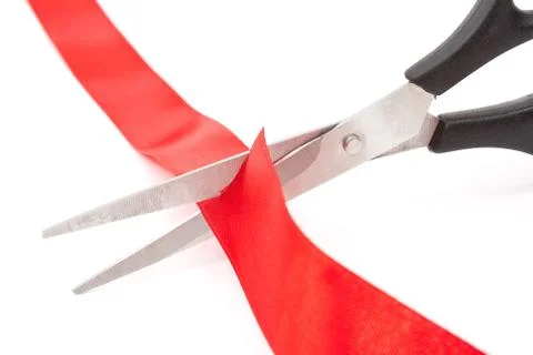 Scissors cutting red ribbon Stock Photos