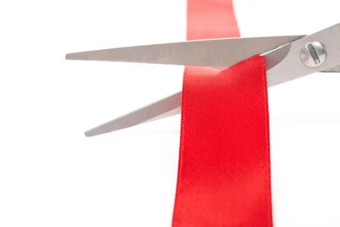 Scissors cutting red ribbon Stock Photos