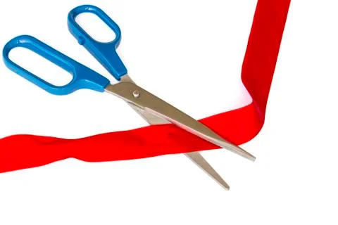 Scissors cutting a red ribbon Stock Photos