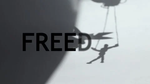 Scissors cutting the rope on which the puppet hangs on the shadow on white Stock Footage 280918361