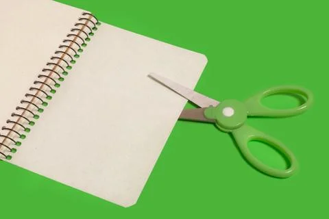 Scissors cutting sheet of paper Stock Photos