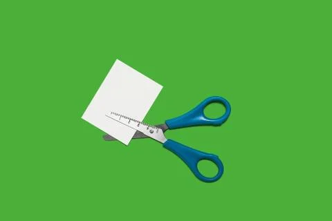 Scissors cutting small paper Stock Photos