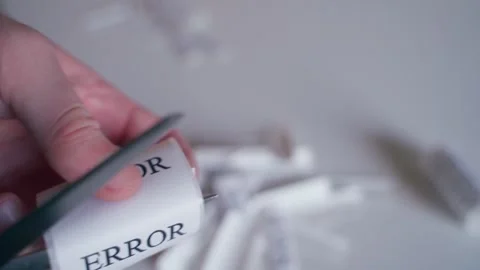 Scissors cutting stickers with the word ERROR, close-up Stock Footage 323374298