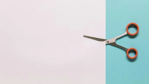 Scissors cutting white paper Stock Photos