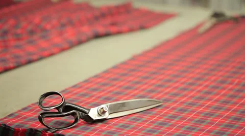 Scissors on a flat squared red texture Stock Footage 31442374