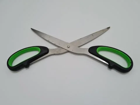 Scissors with green handles Stock Photos