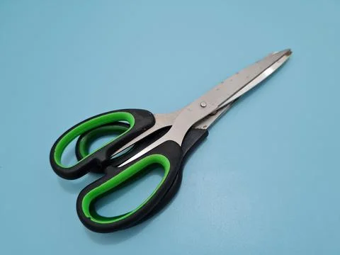 Scissors with green handles Stock Photos