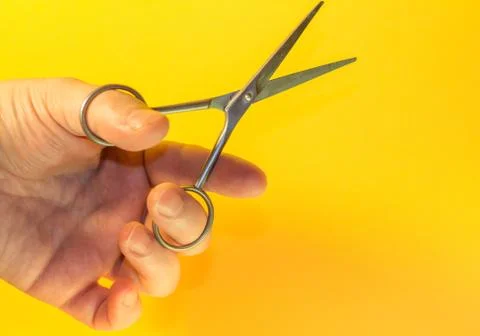 Scissors in hand Stock Photos