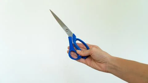 Scissors in hand on white background isolated Stock Photos