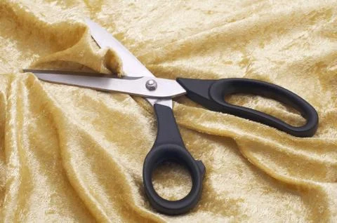 Scissors on material Stock Photos