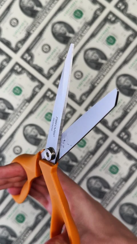 Scissors with orange finger holes are opened and closed. Uncut sheet of two Stock Footage 325079716